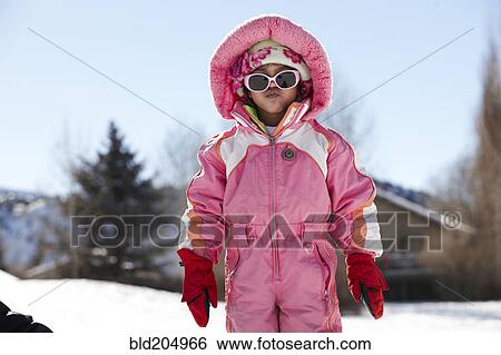 Stock Photograph - Mixed race girl wearing snowsuit. Fotosearch