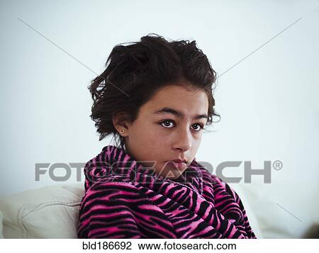 Stock Image - Mixed race girl wrapped in bathrobe. Fotosearch