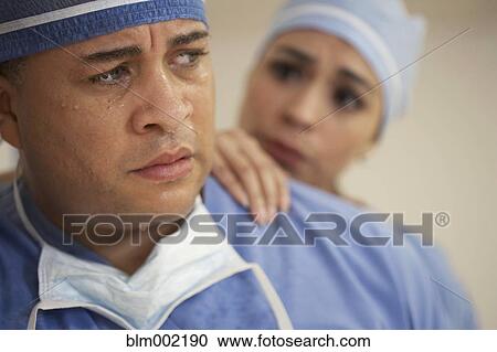 Mixed Race male doctor being comforted by coworker View Large Photo Image Stock Image - Mixed Race male doctor being comforted by coworker. Fotosearch