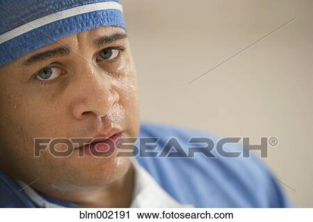 Mixed Race male doctor with sweat on face View Large Photo Image Stock Image - Mixed Race male doctor with sweat on face. Fotosearch