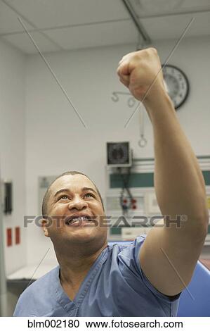 Mixed Race male medical professional raising fist View Large Photo Image Stock Image - Mixed Race male medical professional raising fist. Fotosearch