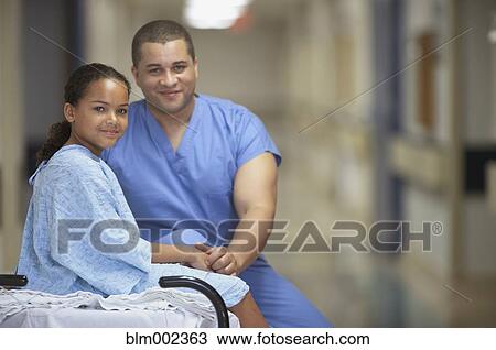 Stock Image - Mixed Race male medical professional with patient. Fotosearch