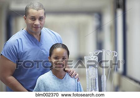 Stock Image - Mixed Race male medical professional with patient. Fotosearch