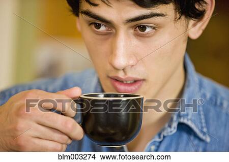 Picture - Mixed race man drinking coffee. Fotosearch