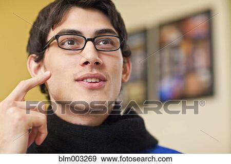 Mixed race man in eyeglasses talking View Large Photo Image Stock Photo - Mixed race man in eyeglasses talking. Fotosearch