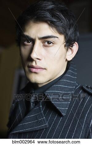 Picture - Mixed race man in fashionable coat. Fotosearch