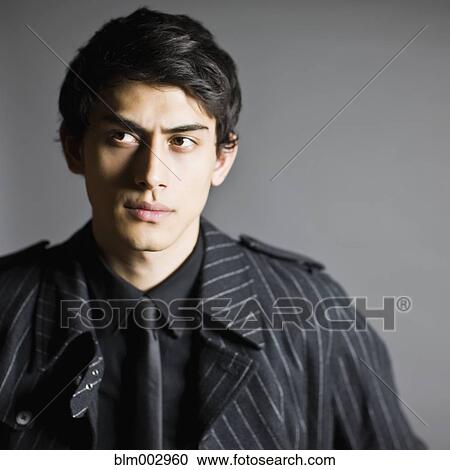 Stock Image - Mixed race man in fashionable coat. Fotosearch
