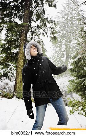 Mixed race man in hooded coat outdoors in snowfall View Large Photo Image Stock Image - Mixed race man in hooded coat outdoors in snowfall. Fotosearch