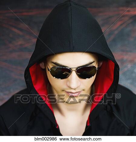 Mixed race man in hooded jacket and sunglasses View Large Photo Image Stock Photograph - Mixed race man in hooded jacket and sunglasses. Fotosearch
