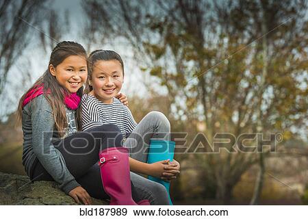 Mixed race sisters smiling outdoors View Large Photo Image Stock Photo - Mixed race sisters smiling outdoors. Fotosearch