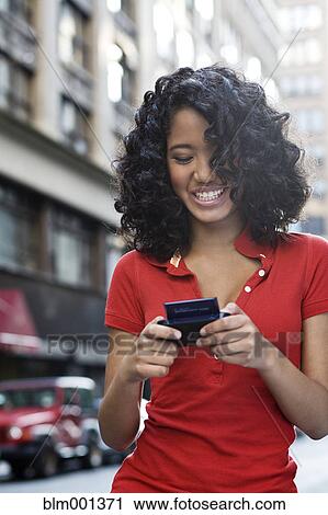 Mixed race teenage girl text messaging View Large Photo Image Stock Image - Mixed race teenage girl text messaging. Fotosearch