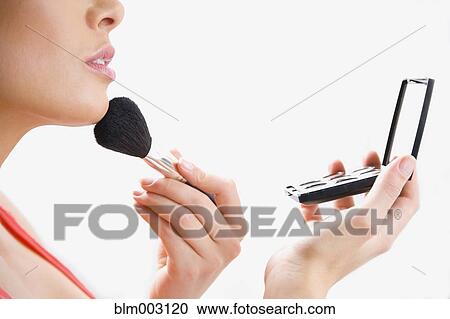 Mixed race woman applying makeup View Large Photo Image Stock Image - Mixed race woman applying makeup. Fotosearch