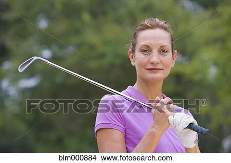 Picture - Mixed race woman holding golf club. Fotosearch