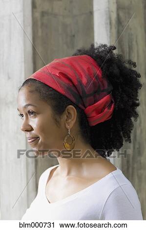 Stock Image - Mixed race woman in traditional headscarf. Fotosearch