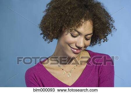 Stock Image - Mixed Race woman looking down. Fotosearch