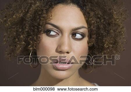 Stock Photo - Mixed Race woman looking sideways. Fotosearch