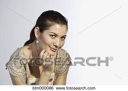Mixed Race woman resting chin on hand View Large Photo Image Stock Photograph - Mixed Race woman resting chin on hand. Fotosearch