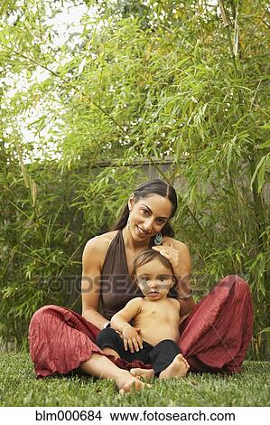 Mixed race woman sitting outdoors with son View Large Photo Image Picture - Mixed race woman sitting outdoors with son. Fotosearch