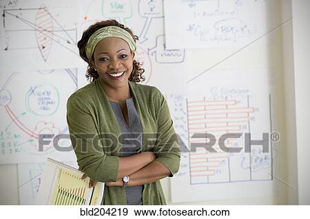 Stock Photo - Mixed race woman smiling in classroom. Fotosearch