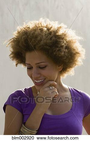 Stock Image - Mixed race woman smiling outdoors. Fotosearch