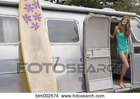 Picture - Mixed race woman standing in doorway of camper. Fotosearch