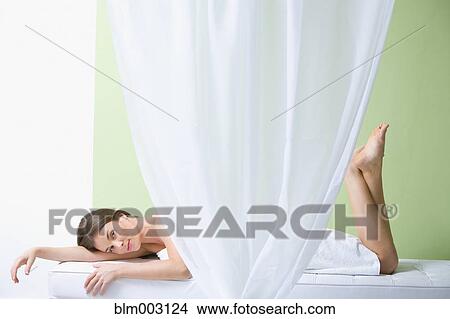 Picture - Mixed race woman waiting for spa treatment. Fotosearch