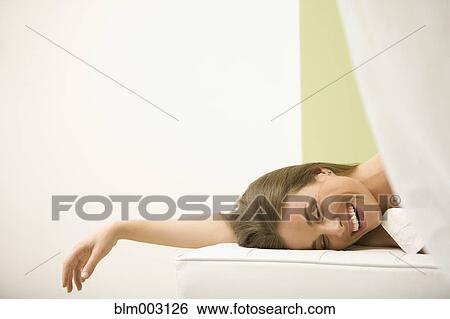 Stock Photograph - Mixed race woman waiting for spa treatment. Fotosearch
