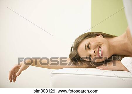 Stock Photography - Mixed race woman waiting for spa treatment. Fotosearch