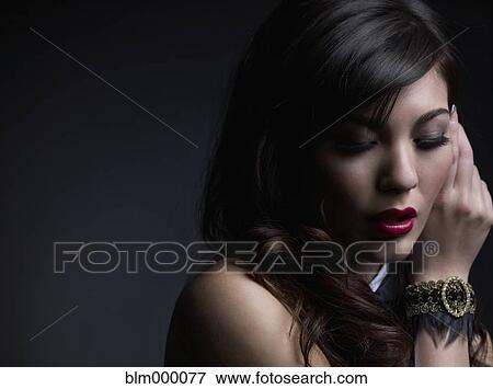 Stock Photo - Mixed Race woman wearing bracelet. Fotosearch