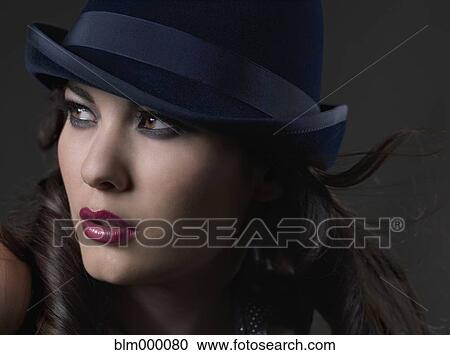Stock Image - Mixed Race woman wearing hat. Fotosearch