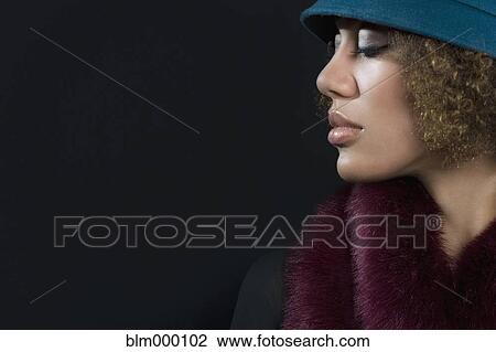 Stock Image - Mixed Race woman wearing hat. Fotosearch