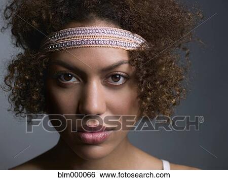 Stock Photograph - Mixed Race woman wearing headband. Fotosearch