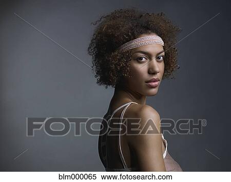 Stock Photography - Mixed Race woman wearing headband. Fotosearch