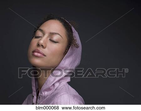 Stock Photo - Mixed Race woman wearing hooded shirt. Fotosearch