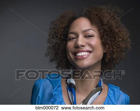 Stock Image - Mixed Race woman wearing scarf around neck. Fotosearch