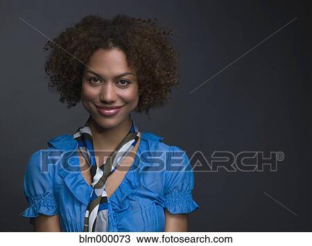 Stock Image - Mixed Race woman wearing scarf around neck. Fotosearch