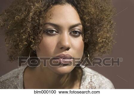 Stock Image - Mixed Race woman with curly hair. Fotosearch