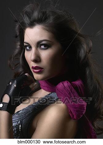 Stock Image - Mixed Race woman with hair blowing. Fotosearch