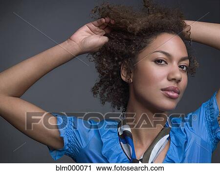 Mixed Race woman with hands in hair View Large Photo Image Stock Image - Mixed Race woman with hands in hair. Fotosearch