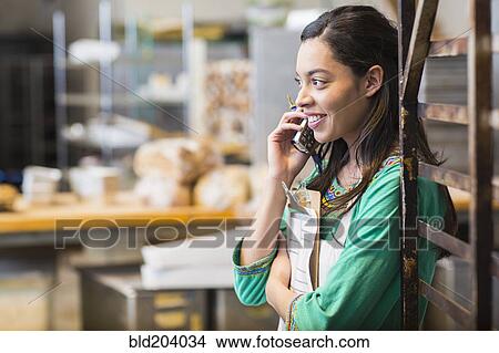 Mixed race woman working in bakery kitchen View Large Photo Image Picture - Mixed race woman working in bakery kitchen. Fotosearch