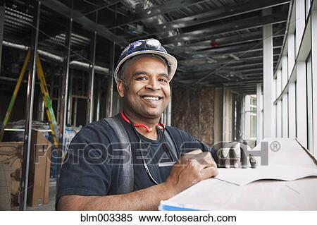 Mixed race worker on construction site View Large Photo Image Stock Photography - Mixed race worker on construction site. Fotosearch