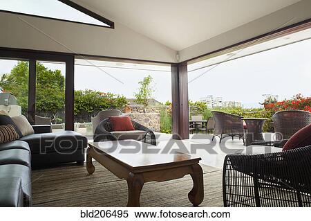 Stock Photography - Modern living room overlooking patio. Fotosearch