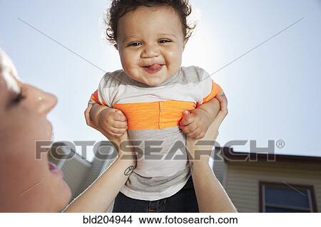 Mother and baby playing in backyard View Large Photo Image Picture - Mother and baby playing in backyard. Fotosearch