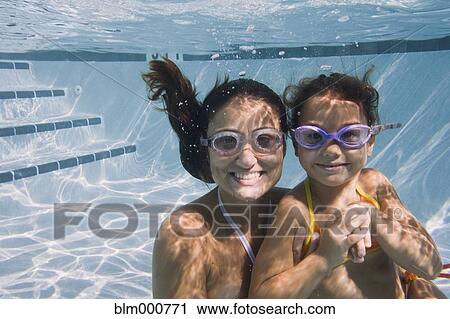 Mother and daughter swimming in swimming pool View Large Photo Image Stock Image - Mother and daughter swimming in swimming pool. Fotosearch