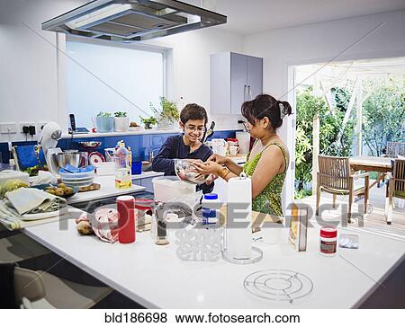 Stock Photo - Mother and son cooking in kitchen. Fotosearch