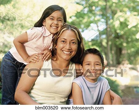 Stock Image - Mother, daughter and son smiling. Fotosearch