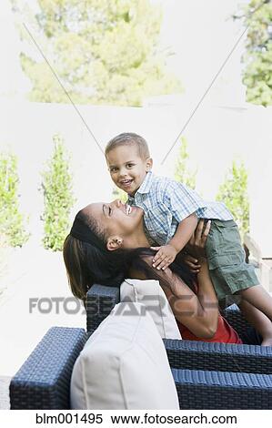 Mother hugging son on patio View Large Photo Image Stock Photography - Mother hugging son on patio. Fotosearch