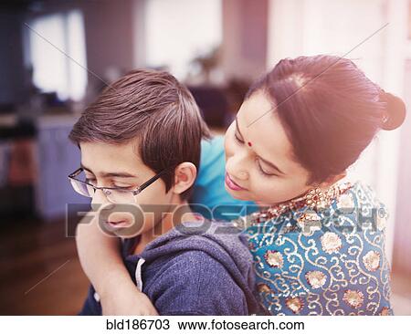 Mother hugging son View Large Photo Image Stock Image - Mother hugging son. Fotosearch