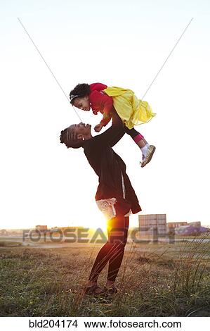 Picture - Mother playing with daughter on beach. Fotosearch