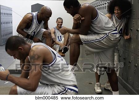 Multi-ethnic basketball players dressing in locker room View Large Photo Image Stock Photography - Multi-ethnic basketball players dressing in locker room. Fotosearch